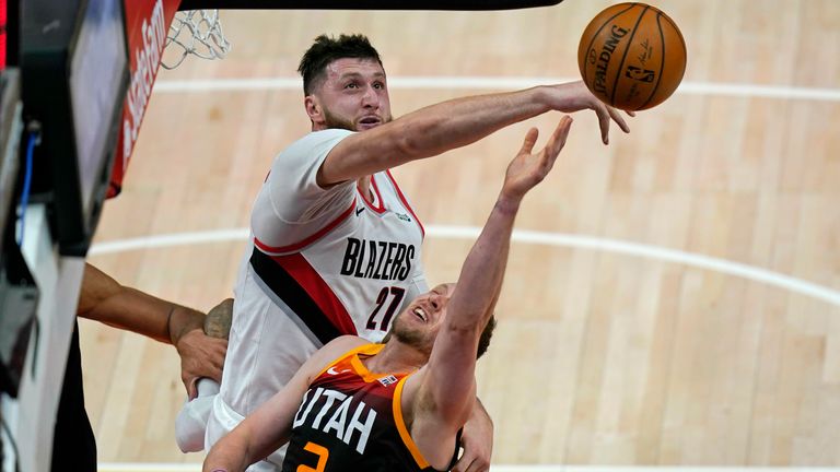Utah Jazz guard Joe Ingles (2) has his shot blocked by Portland Trail Blazers center Jusuf Nurkic (27) during the first half of an NBA basketball game Wednesday, May 12, 2021, in Salt Lake City.