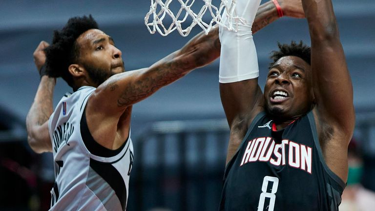 Houston Rockets forward Jae&#39;Sean Tate, right, shoots over Portland Trail Blazers forward Derrick Jones Jr., during the first half of an NBA basketball game in Portland, Ore., Monday, May 10, 2021. 