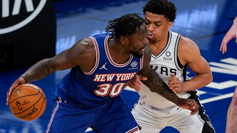 New York Knicks&#39; Julius Randle (30) is defended by San Antonio Spurs&#39; Keldon Johnson (3) during the first half of an NBA basketball game Thursday, May 13, 2021, in New York.