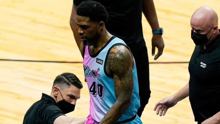 Udonis Haslem is escorted off the court after being ejected just three minutes into his season debut