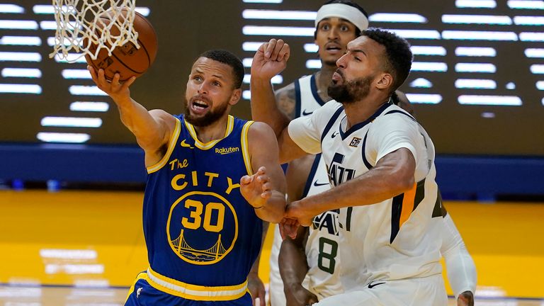 Golden State Warriors guard Stephen Curry (30) shoots against Utah Jazz center Rudy Gobert during the second half of an NBA basketball game in San Francisco, Monday, May 10, 2021.