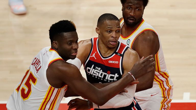 Atlanta Hawks&#39; Clint Capela, left, guards Washington Wizards&#39; Russell Westbrook in the second half of an NBA basketball game Monday, May 10, 2021, in Atlanta.