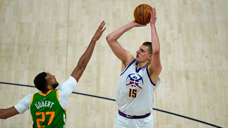 Denver Nuggets center Nikola Jokic shoots as Utah Jazz center Rudy Gobert defends