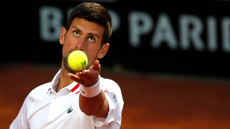 Novak Djokovic of Serbia serves the ball to Taylor Fritz of the United States during their match at the Italian Open tennis tournament, in Rome, Tuesday, May 11, 2021. (AP Photo/Alessandra Tarantino)