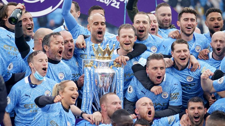 Pep Guardiola celebrates winning the Premier League title with his players and backroom staff