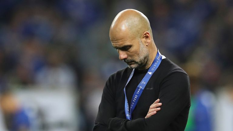 Manchester City&#39;s head coach Pep Guardiola reacts during awarding ceremony after the Champions League final soccer match between Manchester City and Chelsea at the Dragao Stadium in Porto, Portugal, Saturday, May 29, 2021