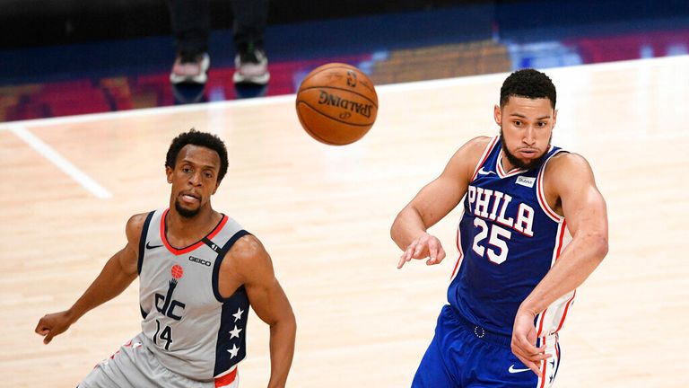 Philadelphia 76ers guard Ben Simmons (25) passes the ball next to Washington Wizards guard Ish Smith (14) during the second half of Game 3 in a first-round NBA basketball playoff series, Saturday, May 29, 2021, in Washington. (AP Photo/Nick Wass)