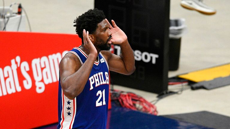 Philadelphia 76ers center Joel Embiid (21) gestures to the crowd after his dunk during the first half of Game 3 in a first-round NBA basketball playoff series against the Washington Wizards, Saturday, May 29, 2021, in Washington. (AP Photo/Nick Wass)