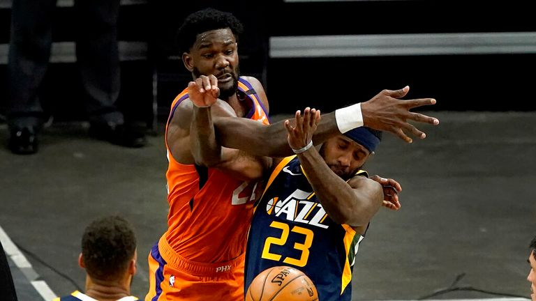 Phoenix Suns center Deandre Ayton knocks the ball away from Utah Jazz forward Royce O'Neale (23) during the first half of an NBA basketball game, Friday, April 30, 2021, in Phoenix. (AP Photo/Matt York)
