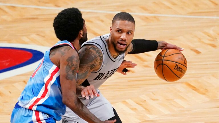 Portland Trail Blazers guard Damian Lillard, left, drives against Brooklyn Nets guard Kyrie Irving during the second half of an NBA basketball game, Friday, April 30, 2021, in New York. (AP Photo/Mary Altaffer)