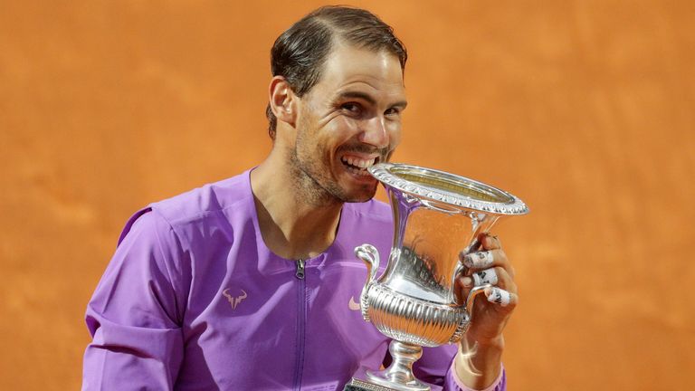 Spain's Rafael Nadal celebrates with the trophy after winning the Italian Open tennis tournament, in Rome, Sunday, May 16, 2021. Nadal defeated Serbia's Novak Djokovic 7-5, 1-6, 6-3. (AP Photo/Gregorio Borgia)