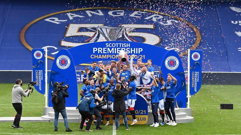 GLASGOW, SCOTLAND - MAY 15: Rangers'  James Tavernier lifts the Premiership trophy during the Scottish Premiership match between Rangers and Aberdeen at Ibrox Stadium, on May 15, 2021, in Glasgow, Scotland.  (Photo by Rob Casey / SNS Group)
