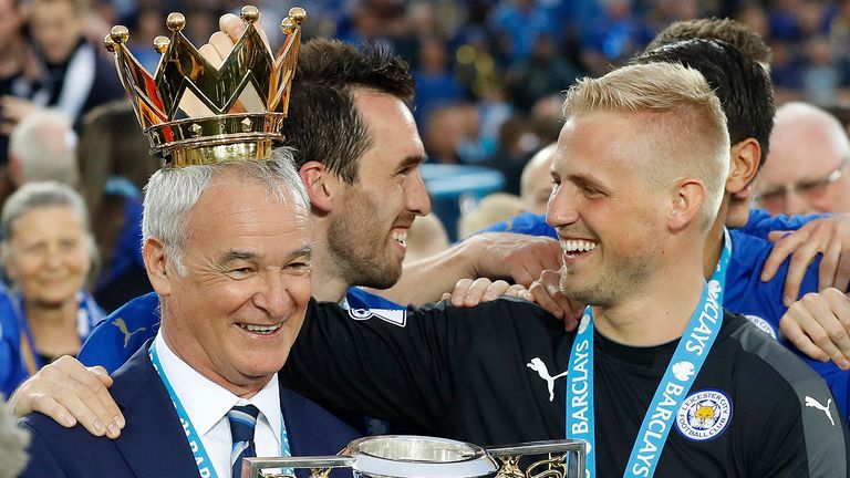 FILE - In this May 7, 2016 file photo, Leicester's team manager Claudio Ranieri gets a crown by Leicester's goalkeeper Kasper Schmeichel as they lift the trophy as Leicester City celebrate becoming the English Premier League soccer champions at King Power stadium in Leicester, England. Claudio Ranieri loves a challenge and his latest job at Sampdoria will be anything but straightforward. (AP Photo/Matt Dunham)