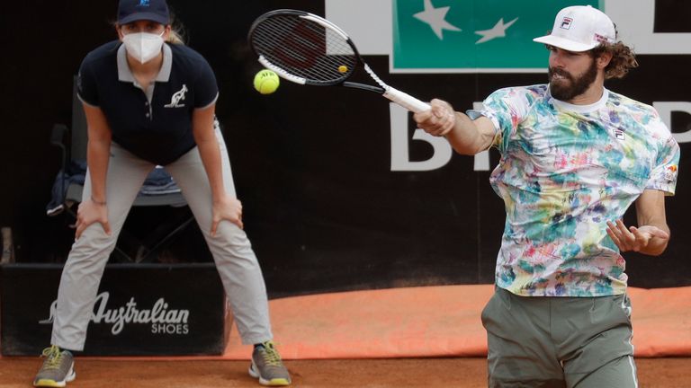 Reilly Opelka, of the United States, returns the ball to Argentina's Federico Delbonis during their quarter-final match at the Italian Open tennis tournament, in Rome, Friday, May 14, 2021. (AP Photo/Gregorio Borgia)