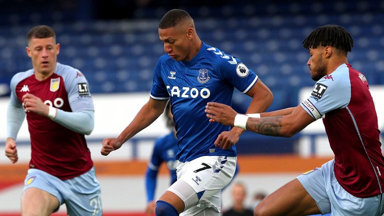 Richarlison looks to escape Tyrone Mings at Goodison Park