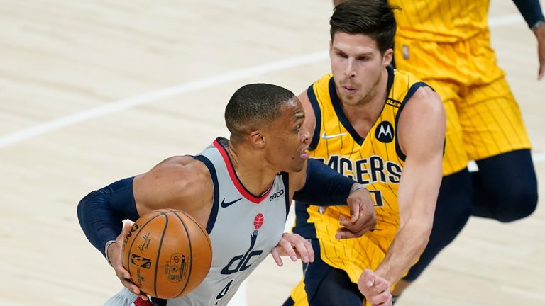 Washington Wizards&#39; Russell Westbrook (4) goes to the basket against -Indiana Pacers&#39; Doug McDermott (20) during the first half of an NBA  basketball game, Saturday, May 8, 2021, in Indianapolis. (AP Photo/Darron Cummings) 