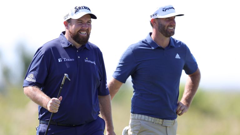 Shane Lowry of Ireland and Dustin Johnson of the United States walk during a practice round prior to the 2021 PGA Championship at Kiawah Island Resort's Ocean Course