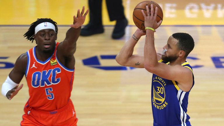 Golden State Warriors&#39; Stephen Curry, right,  shoots a three point basket against Oklahoma City Thunder Luguentz Dort during the first half of an NBA basketball game in San Francisco, Saturday, May 8, 2021. (AP Photo/Jed Jacobsohn)