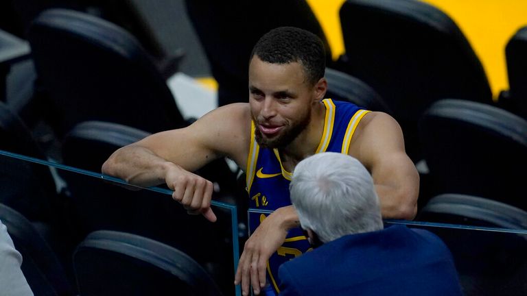 Golden State Warriors guard Stephen Curry, top, talks with his former Davidson college head coach, Bob McKillop, after an NBA basketball game between the Warriors and the Phoenix Suns in San Francisco, Tuesday, May 11, 2021. (AP Photo/Jeff Chiu)