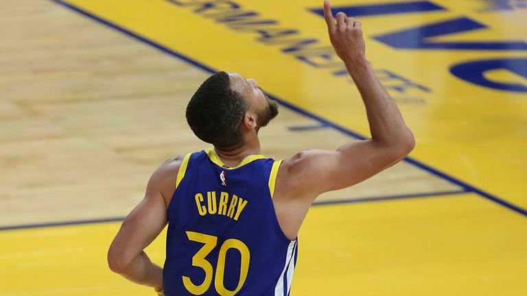 Golden State Warriors&#39; Stephen Curry points to the sky after scoring against the Oklahoma City Thunder during the first half of an NBA basketball game in San Francisco, Saturday, May 8, 2021.