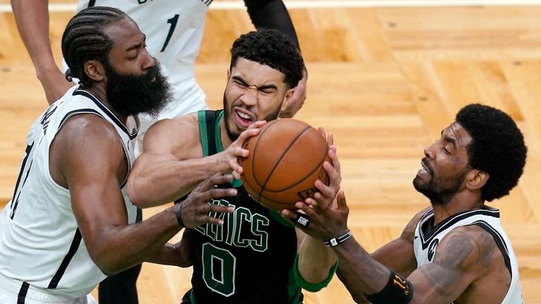 Boston Celtics forward Jayson Tatum drives between Brooklyn Nets guards James Harden and Kyrie Irving in Game 3 of the first-round playoff series
