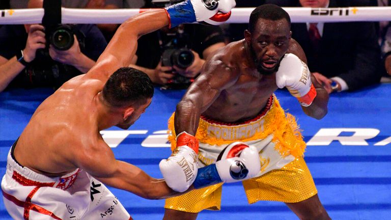 TERENCE CRAWFORD (yellow trunks) and AMIR KHAN battle in a WBO welterweight world championship bout at Madison Square Garden in New York, New York.
