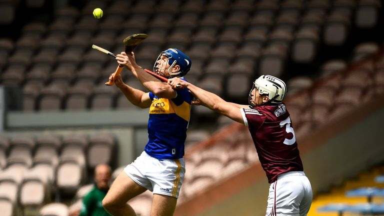 John McGrath of Tipperary in action against Daithí Burke of Galway