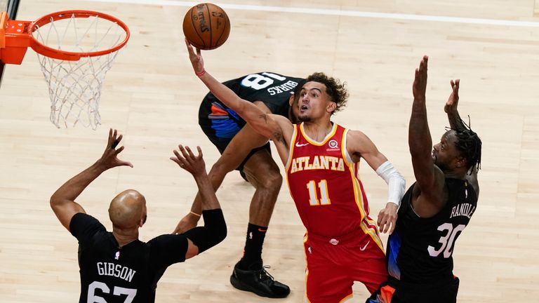 Atlanta Hawks&#39; Trae Young shoots against New York Knicks&#39; Julius Randle and Taj Gibson in Game 3 of an NBA basketball first-round playoff series