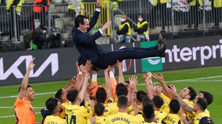 Unai Emery is hoisted aloft in celebration