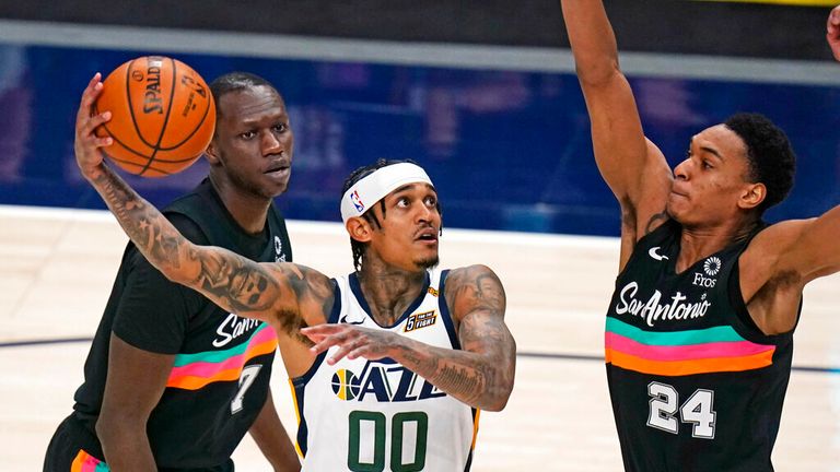 Utah Jazz guard Jordan Clarkson (00) goes to the basket as San Antonio Spurs guard Devin Vassell (24) defends during the second half of an NBA basketball game Wednesday, May 5, 2021, in Salt Lake City. (AP Photo/Rick Bowmer)
