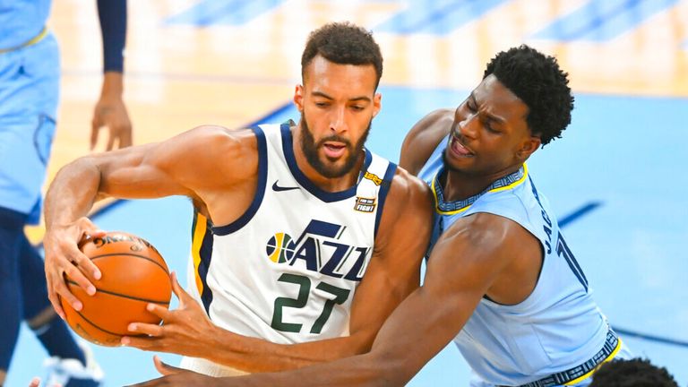 Utah Jazz center Rudy Gobert (27) tries to keep the ball from  forward Jaren Jackson Jr. during the first half of Game 3 of an NBA basketball first-round playoff series Saturday, May 29, 2021, in Memphis, Tenn. (AP Photo/John Amis)