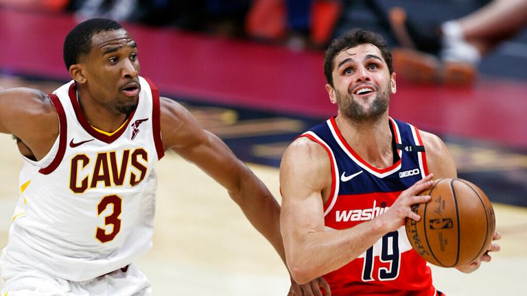 Washington Wizards' Raul Neto (19) goes up to shoot against Cleveland Cavaliers' Jeremiah Martin (3) during the second half of an NBA basketball game, Friday, April 30, 2021, in Cleveland. (AP Photo/Ron Schwane)