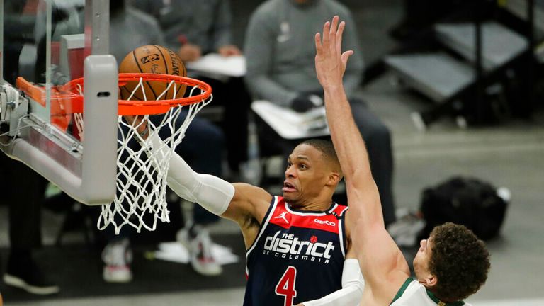 Washington Wizards&#39; Russell Westbrook (4) goes to the hoop against Milwaukee Bucks&#39; Brook Lopez during the first half of an NBA basketball game Wednesday, May 5, 2021, in Milwaukee. (AP Photo/Aaron Gash)