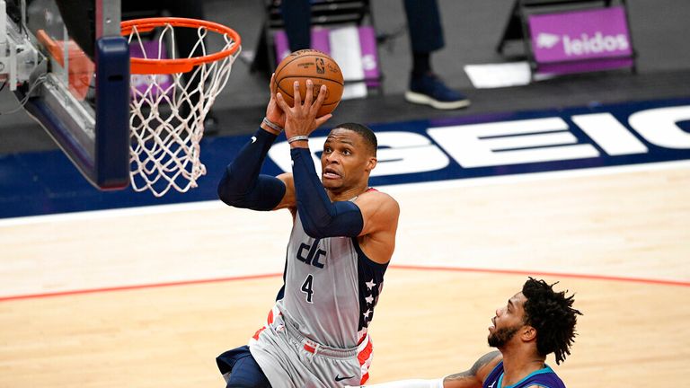 Washington Wizards guard Russell Westbrook (4) goes to the basket past Charlotte Hornets forward Miles Bridges (0) during the first half of an NBA basketball game, Sunday, May 16, 2021, in Washington. (AP Photo/Nick Wass)