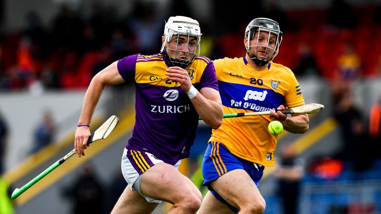 Rory O'Connor of Wexford and Jack Browne of Clare race for possession