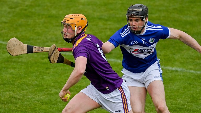 Simon Donohoe of Wexford in action against PJ Scully of Laois