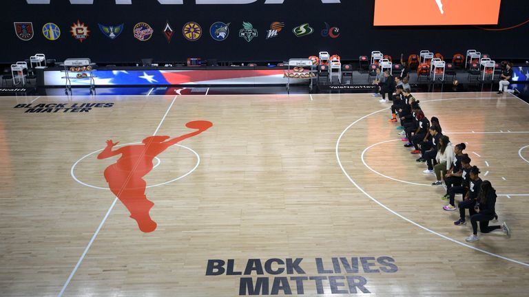 Members of the Connecticut Sun team kneel during the playing of the national anthem before a WNBA basketball game against the Washington Mystics (AP Photo/Phelan M. Ebenhack)