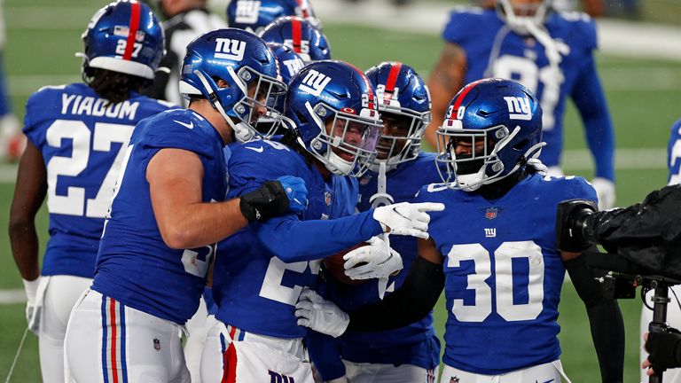 The Giants celebrate McKinney's interception against the Cowboys. (AP)