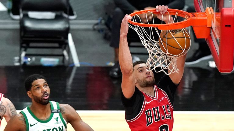 Chicago Bulls guard Zach LaVine dunks past Boston Celtics center Tristan Thompson