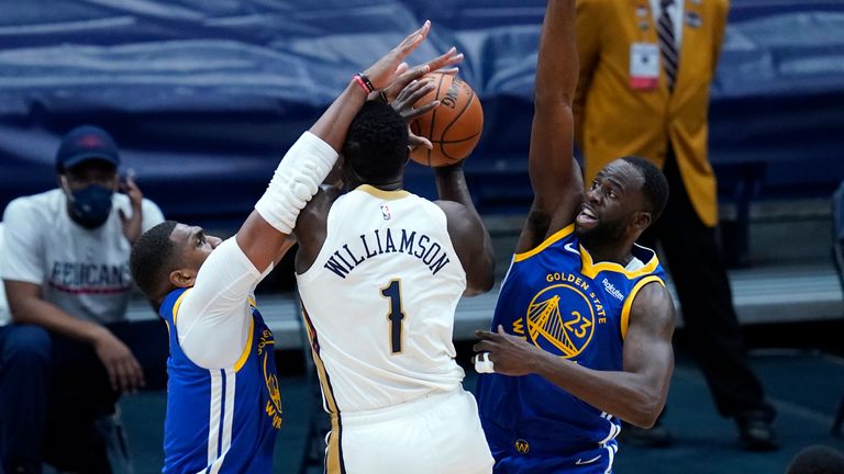 New Orleans Pelicans forward Zion Williamson is double teamed by Golden State Warriors forward Draymond Green and center Kevon Looney