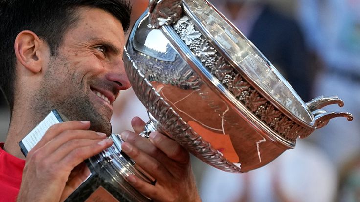 Serbia's Novak Djokovic smiles while holding the cup after defeating Stefanos Tsitsipas of Greece during their final match of the French Open tennis tournament at the Roland Garros stadium Sunday, June 13, 2021 in Paris. Djokovic won 6-7 (6), 2-6, 6-3, 6-2, 6-4. (AP Photo/Michel Euler)