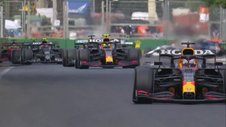 Verstappen holds the lead as the top three go into Turn One in formation.