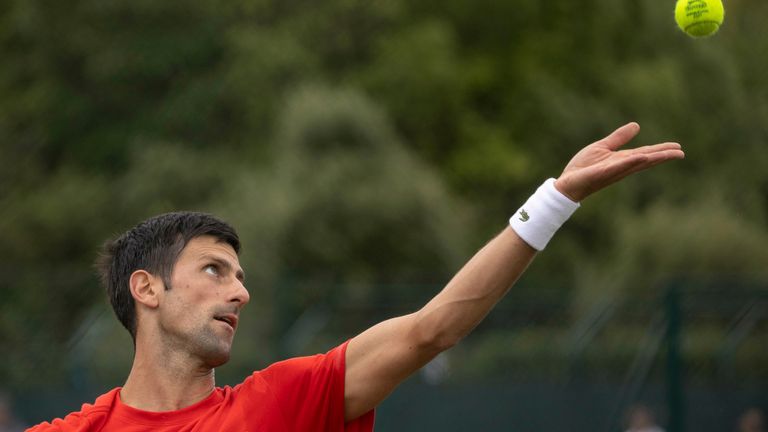 Serbia&#39;a Novak Djokovic serves, during his practice match, prior to the Wimbledon Tennis Championships in London, Saturday June 26, 2021.