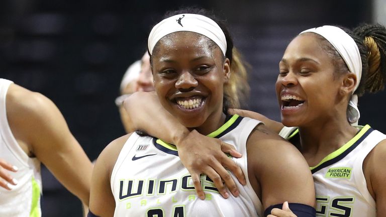 Arike Ogunbowale (24) of the Dallas Wings celebrates with teammates Isabelle Harrison (20) and Moriah Jefferson (4) after making the game-winning basket 