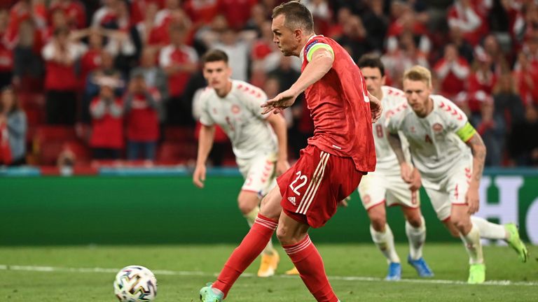 Russia's Artem Dzyuba scores his side's opening goal from a penalty shot during the Euro 2020 soccer championship group B match between Russia and Denmark 