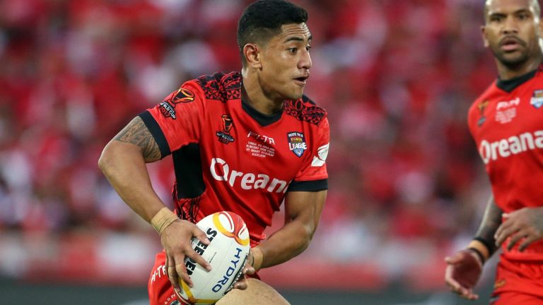 Tonga's Ata Hingano (L) makes a break during the Rugby League World Cup men's semi-final match between Tonga and England at Mt Smart Stadium in Auckland on November 25, 2017. 