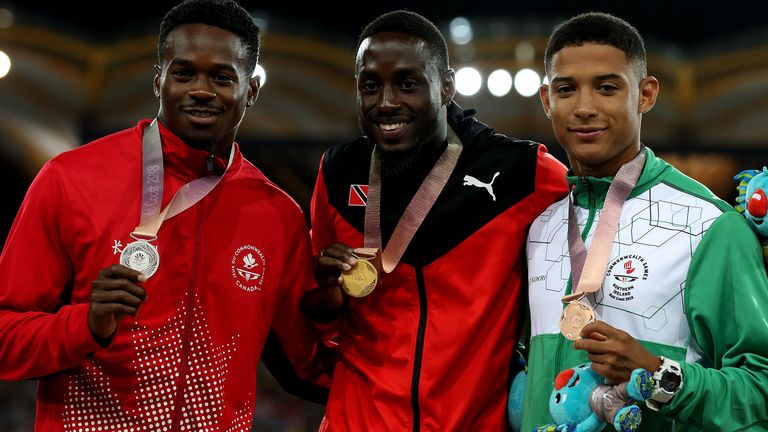 Trinidad and Tobago's Jereem Richards (centre), Canada's Aaron Brown (left) and Northern Ireland's Leon Reid with gold, silver and bronze medals for the Men's 200m at the 2018 Commonwealth Games