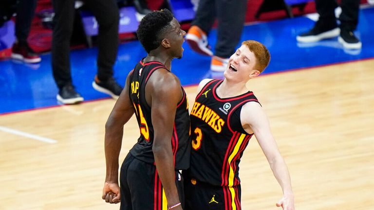 Atlanta Hawks&#39; Kevin Huerter, right, and Clint Capela celebrate during the final seconds of Game 7 in a second-round NBA basketball playoff series against the Philadelphia 76ers, Sunday, June 20, 2021, in Philadelphia. (AP Photo/Matt Slocum)