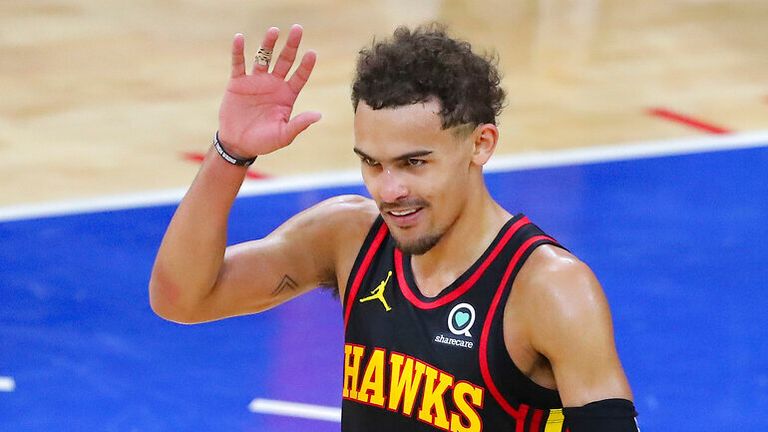Atlanta Hawks guard Trae Young waves to booing Philadelphia 76ers fans after winning Game 7 of their NBA Eastern Conference semifinal game to advance, Sunday, June 20, 2021, in Philadelphia. (Curtis Compton/Atlanta Journal-Constitution via AP)
