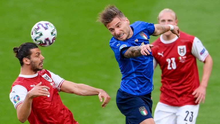 Austria's Aleksandar Dragovic, left, and Italy's Ciro Immobile compete to head the ball during the Euro 2020 soccer championship round of 16 match between Italy and Austria at Wembley Stadium, London, Saturday, June 26, 2021. (Laurence Griffiths/Pool Photo via AP)